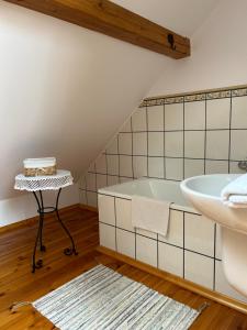 a bathroom with a bath tub and a sink at Dworek Szyszki - Kaszuby in Liniewko +33 photos
