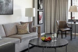 a living room with a couch and a table with a bowl of fruit at The Ritz-Carlton Atlanta in Atlanta