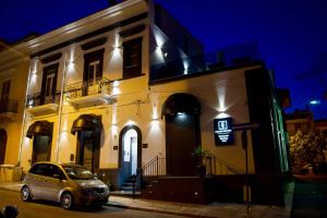 a car parked in front of a building at night at Palazzo Simposio in Torre Maggiore