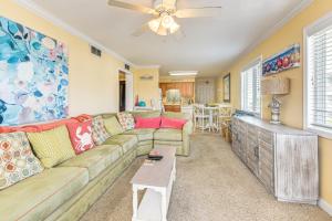 a living room with a couch and a ceiling fan at Steps to Beach NMB Condo with Balcony and Pool Access in Myrtle Beach