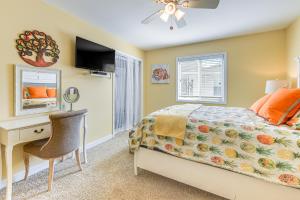 a bedroom with a bed and a desk and a television at Steps to Beach NMB Condo with Balcony and Pool Access in Myrtle Beach +18 photos