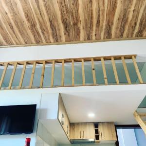a staircase in a house with wooden ceiling at Pogradec Lake Apartments in Pogradec