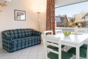 a living room with a table and a couch at Seepferdchen Freetied in Sierksdorf