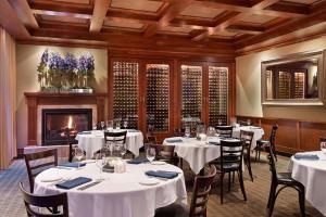 a restaurant with white tables and chairs and a fireplace at The Westin Memphis Beale Street in Memphis