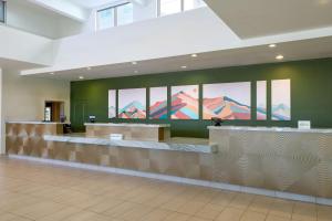a lobby with a waiting area with mountains on the wall at Residence Inn Phoenix Desert View at Mayo Clinic in Phoenix +39 photos