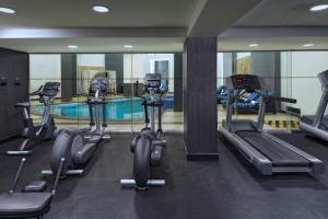 a gym with several treadmills and a swimming pool at Le Méridien Mexico City Reforma in Mexico City