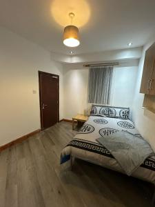 a bedroom with a bed and a table in it at Room 1 in south Yorkshire in Sheffield
