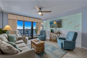 a living room with a couch chairs and a ceiling fan at Sea Marsh II Unit 603 - Oceanfront in Myrtle Beach +67 photos