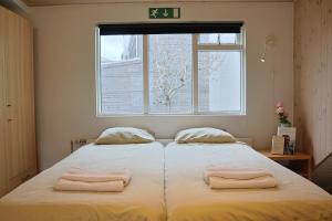 a bedroom with a bed with two towels on it at Ice apartament 1 in Reykjavík
