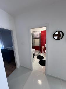 a white room with a bed and a mirror at Apartman Mia Bibinje in Bibinje
