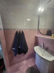 a pink bathroom with a sink and a mirror at Apartament na wyłączność Gdańsk in Gdańsk +15 photos