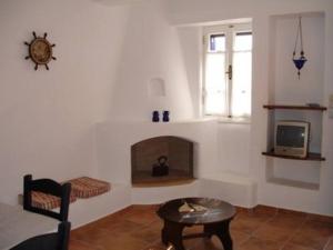 a living room with a fireplace and a tv at Niriedes Villas in Lipsoi