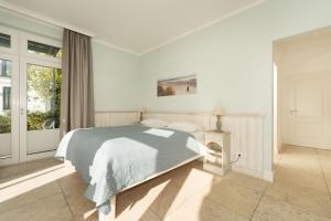 Ένα ή περισσότερα κρεβάτια σε δωμάτιο στο Strandresidenz Vogelflug Sundblick