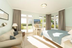 Ένα ή περισσότερα κρεβάτια σε δωμάτιο στο Strandresidenz Vogelflug Sundblick