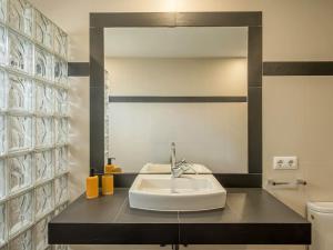 a bathroom with a sink and a mirror at Villa Serena by 3VILLAS in S'Algar