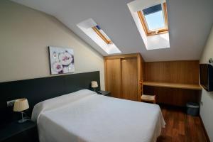 Postel nebo postele na pokoji v ubytování Hostal El Palacio