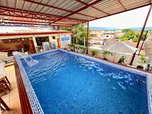 a large blue swimming pool on top of a building at Residencial Brest Amazon Tarapoto in Tarapoto