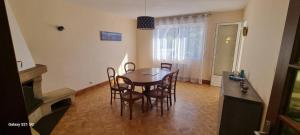 a dining room with a table and chairs at Les sorbiers in Crozon