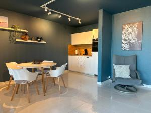 a kitchen and dining room with a table and chairs at Ferienwohnung Münsterblick in Kehl am Rhein