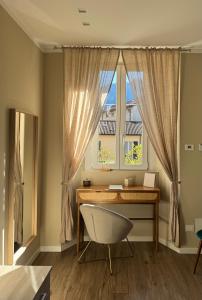 a desk and a chair in a room with a window at SilverHome in Lecco +17 photos