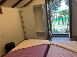 Ένα ή περισσότερα κρεβάτια σε δωμάτιο στο La Rivazza Apartment - Autodromo- Private Parking