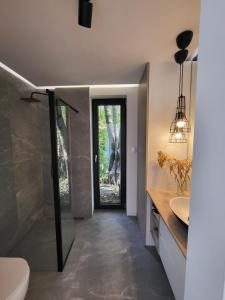 a bathroom with a shower and a toilet and a sink at Leśny Domek - Świekatowo in Świekatowo