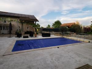 a swimming pool in a yard with a house at Gîte in Saint-Bénigne