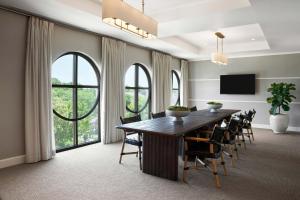 a dining room with a large wooden table and chairs at The Memphian a Tribute Portfolio Hotel in Memphis