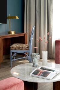 a living room with a coffee table and a chair at The Memphian a Tribute Portfolio Hotel in Memphis