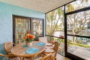 a dining room with a table and chairs and a window at Condo with Patio and Resort Amenities in Fort Pierce! in Fort Pierce