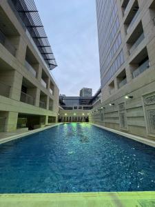 a large swimming pool in the middle of a building at Amman damac tower عبدلي عمان دماك Abdali Boulevard in Amman