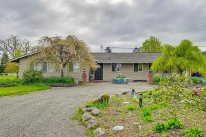 a house with a gravel driveway in front of it at 9 Mi to Spanaway Park Home with Indoor Hot Tub in Graham