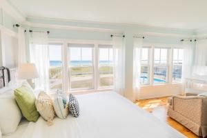 a bedroom with a large bed with a view of the ocean at Ocean House Boutique Hotel & Motel in Old Orchard Beach
