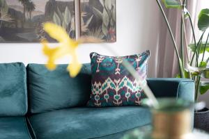 a green couch with a pillow on it in a living room at Strandbungalow Ostsee in Rettin +35 photos