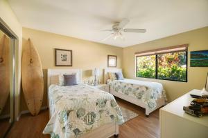 Ένα ή περισσότερα κρεβάτια σε δωμάτιο στο Kauai Vacation Home