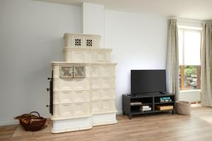 a living room with a white cabinet and a tv at ToHuus in Laboe +10 photos