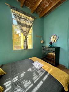 a bedroom with a bed and a window at Mar de Lava in Mexico City