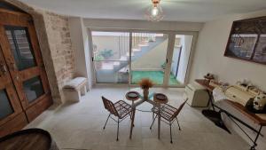a living room with a table and chairs and a staircase at Epoca B&B in Bitetto