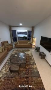 a living room with a couch and a table at Luxury Seaview Apartment in Sharm El Sheikh