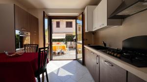 a kitchen with a red counter top and a table at Villa Grifone in Sirmione
