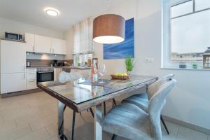 a kitchen with a dining room table and chairs at Blankwasserweg 57 Wohnung 5 in Grömitz
