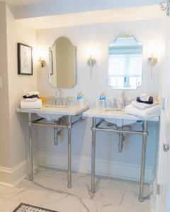 a bathroom with two sinks and a mirror at Justine Inn Savannah in Savannah