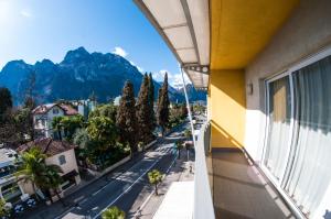 an apartment balcony with a view of a street and mountains at Hotel Primo in Riva del Garda