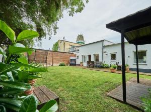 a backyard of a house with a green yard at Ferienbungalow LEO in Petersdorf auf Fehmarn +14 photos