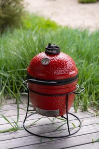 a red toaster sitting on top of a table at Debesu kopa in Nida