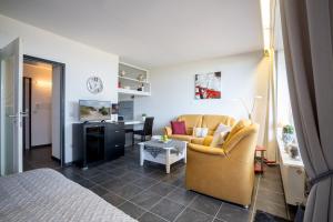 a room with a bed and a couch and a table at Berolina Balkonfeuer in Dahme +25 photos