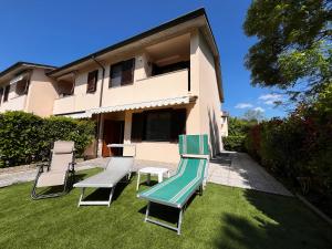 a group of chairs and a slide in front of a house at Villa Grifone in Sirmione