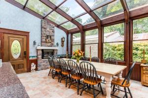 a dining room with a table and chairs and a fireplace at Inn of Saugatuck in Saugatuck