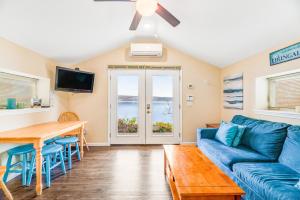 a living room with a blue couch and a table at Live Laugh Lake - A in Rushville