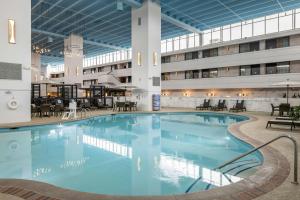 a large pool in a building with tables and chairs at The Inn at Opryland, A Gaylord Hotel in Nashville